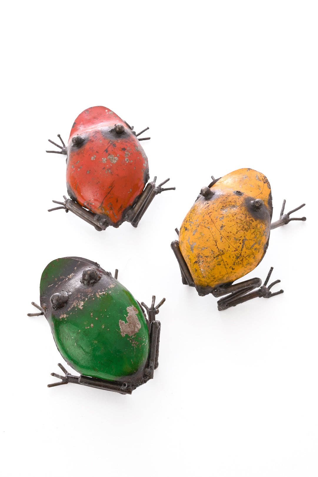 Three colorful metallic frogs, red, yellow, and green - from the back.