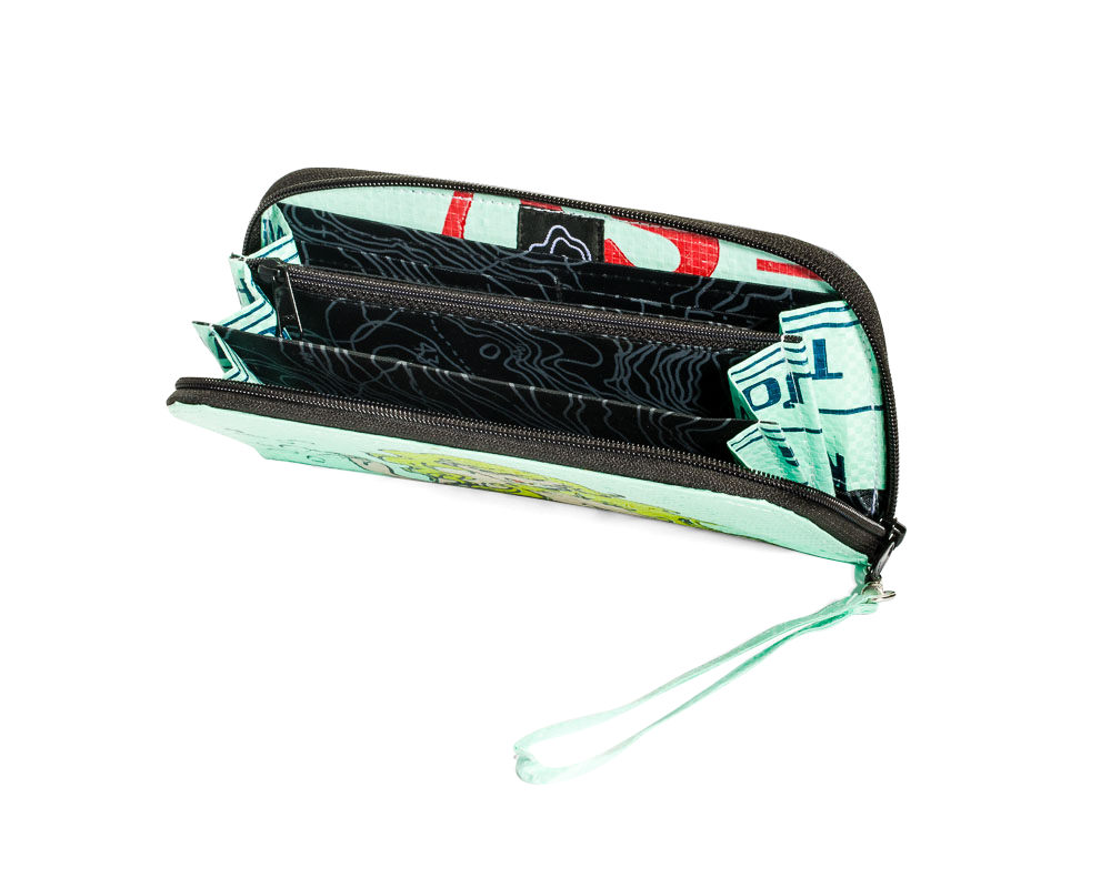Open zip wallet with tassel showing multiple sections inside. Exterior material is upcycled from feed and cement bags, Interior material is recycled from plastic bottles. Each design is unique.