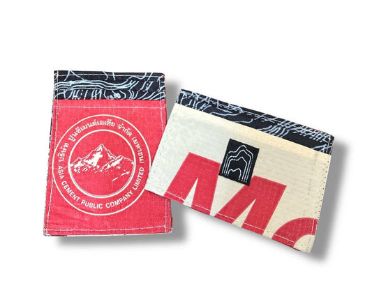 Mini wallets. Exterior material is upcycled from feed and cement bags, Interior material is recycled from plastic bottles. Each design is unique.