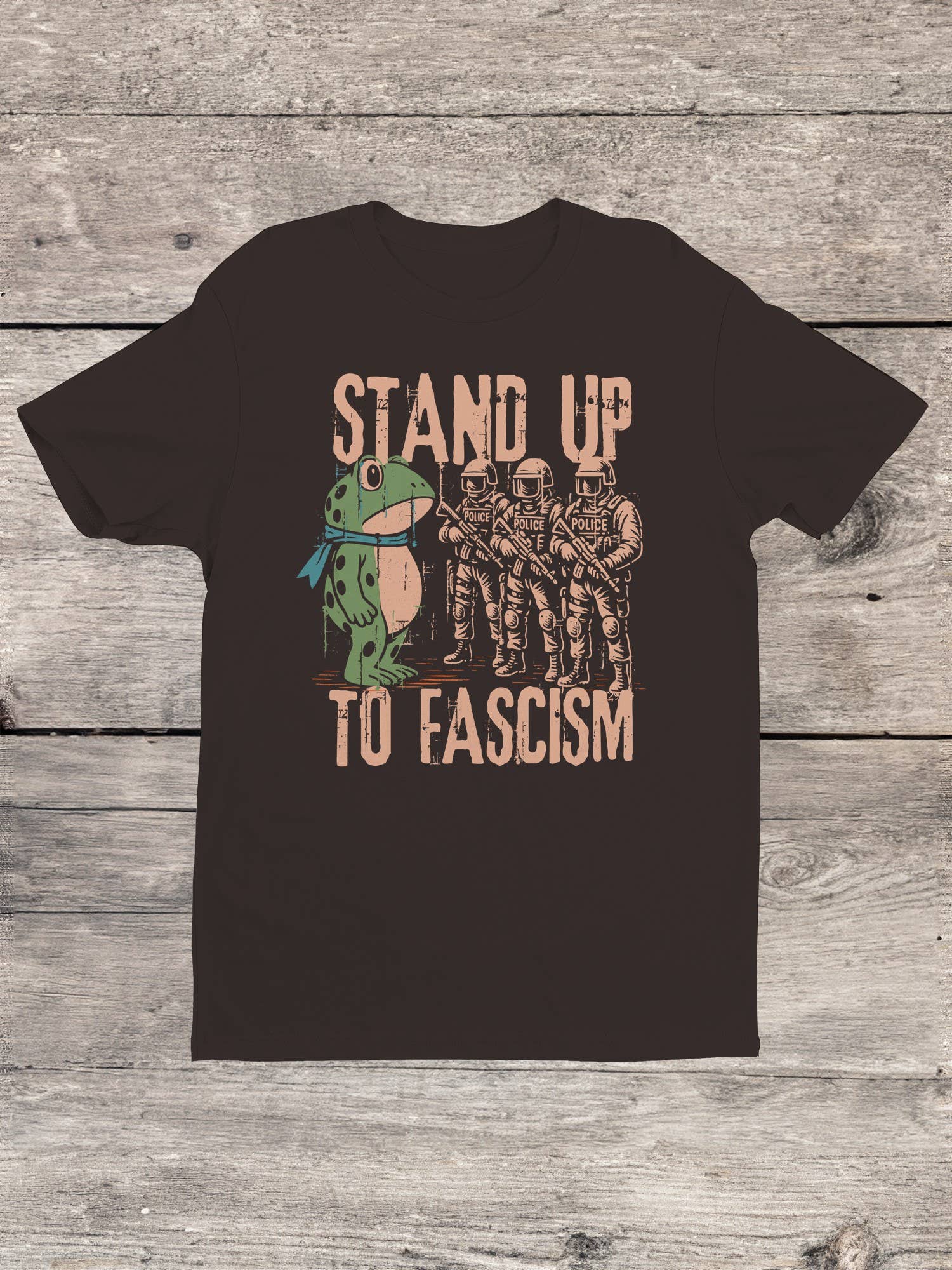 Brown t-shirt with graphic frog protest design and text 'Stand Up To Fascism'