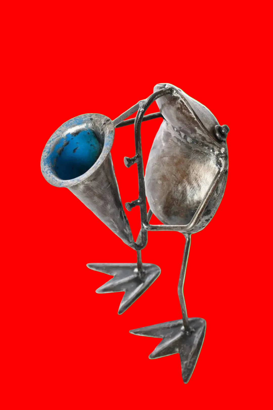 Handcrafted metallic sculpture of a frog playing a horn.