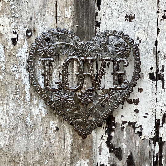 Handmade Haitian hammered metal wall art of a heart with the word Love surrounded by flowers