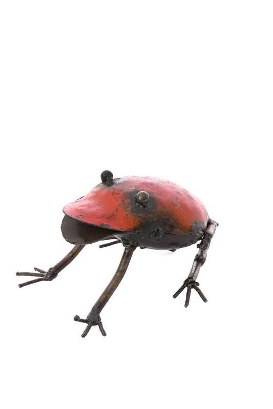 Crouching handcrafted metallic sculpture of a red frog.