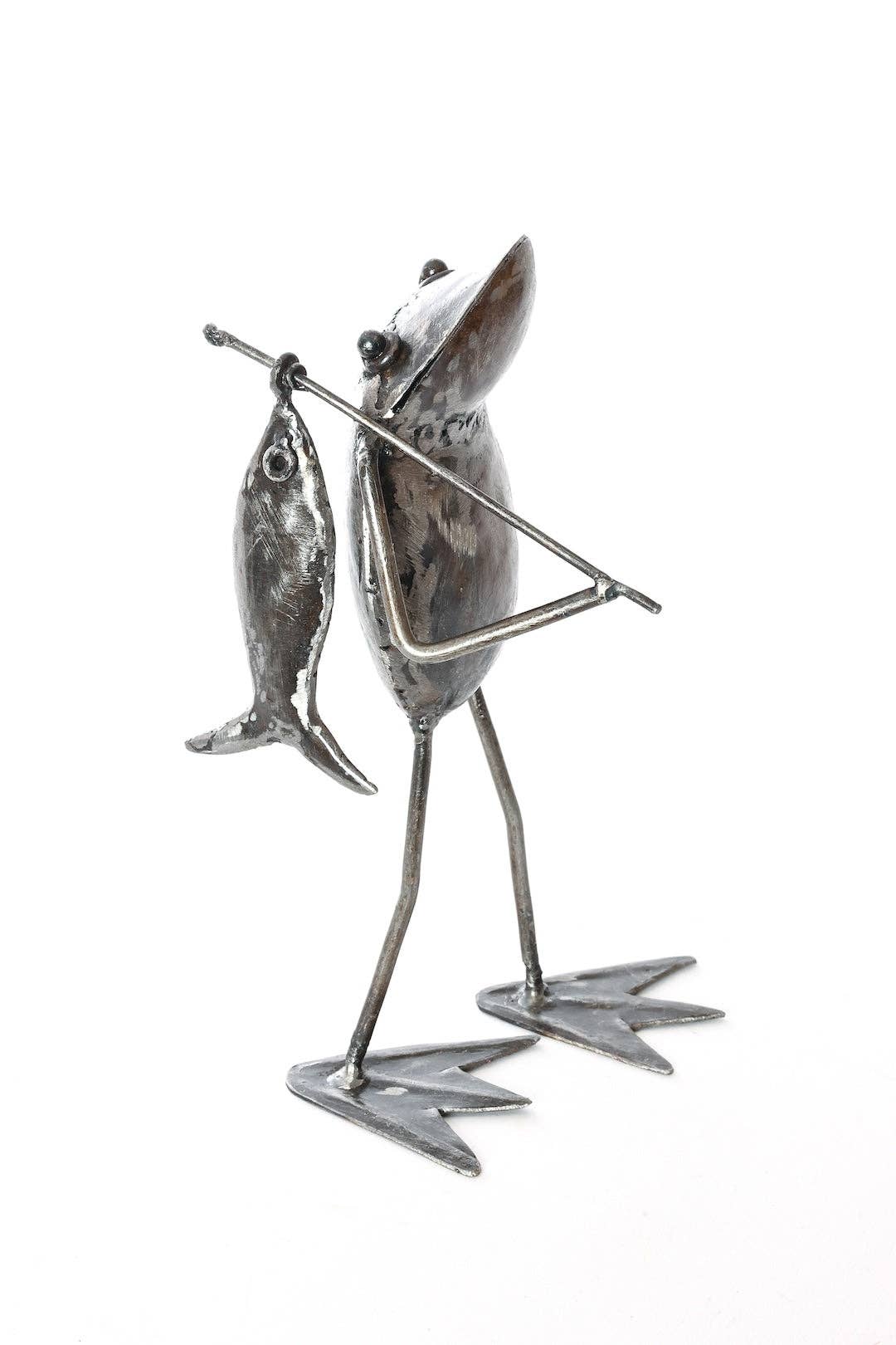 Metallic frog  holding a fishing pole with a fish on the end - facing right
