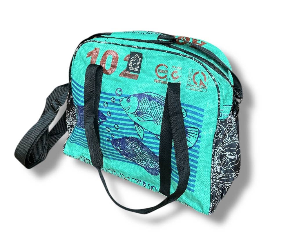 Bowler style duffle bag. Exterior material is upcycled from feed and cement bags, Interior material is recycled from plastic bottles. Each design is unique.