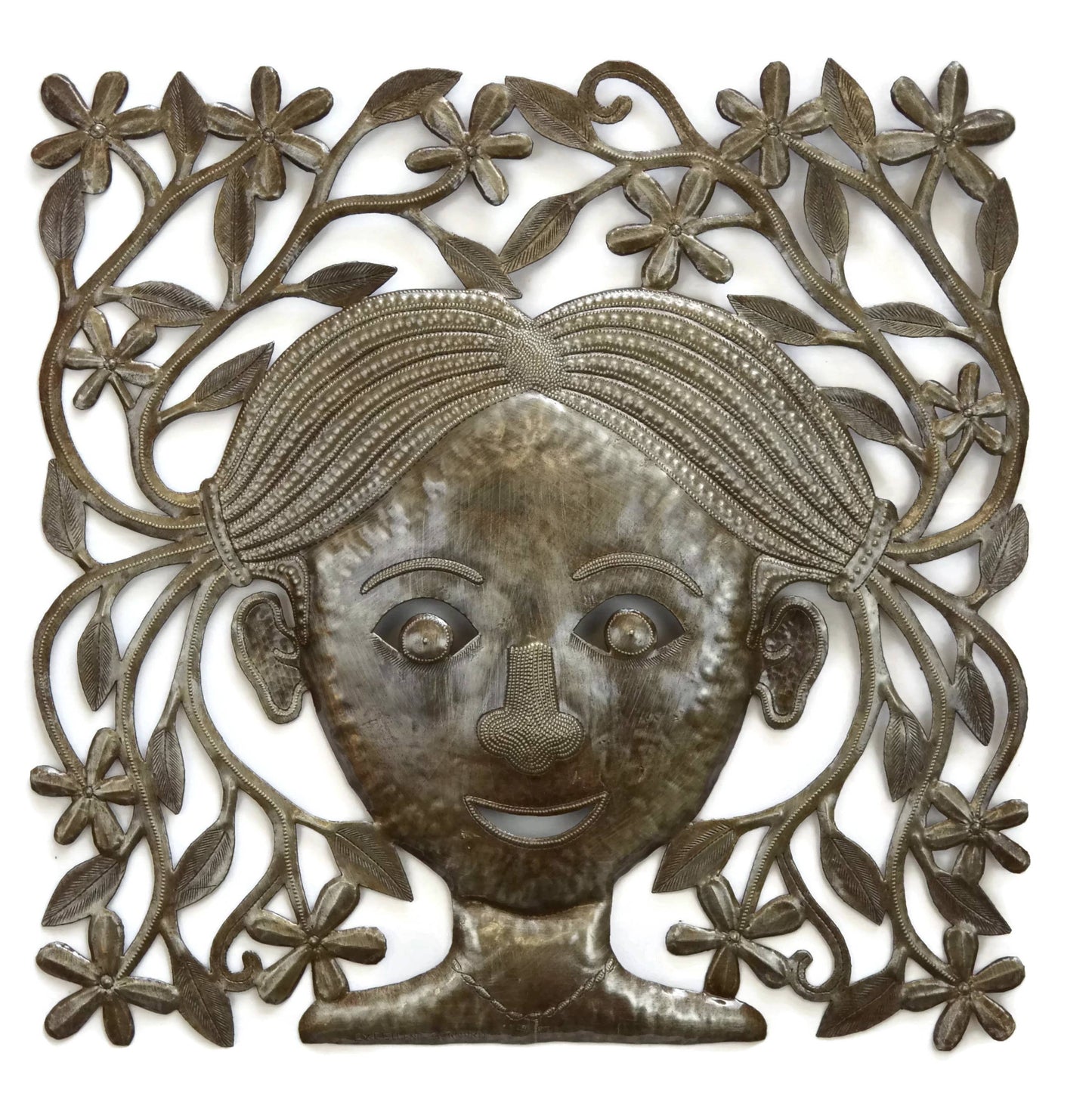 Handmade Haitian hammered metal wall art of a young girl with pigtails