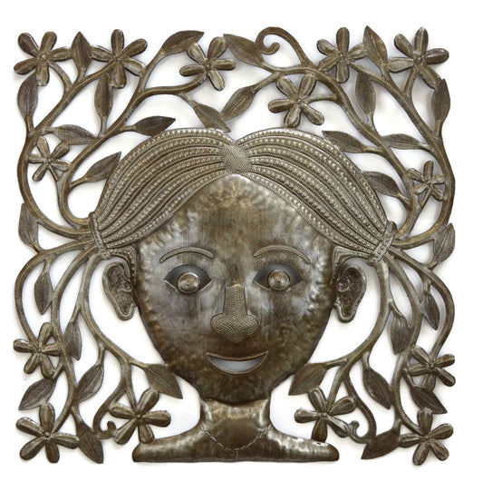 Handmade Haitian hammered metal wall art of a young girl with pigtails