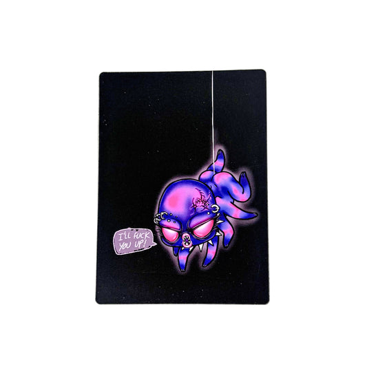 Glowing purple spider on a black card with text