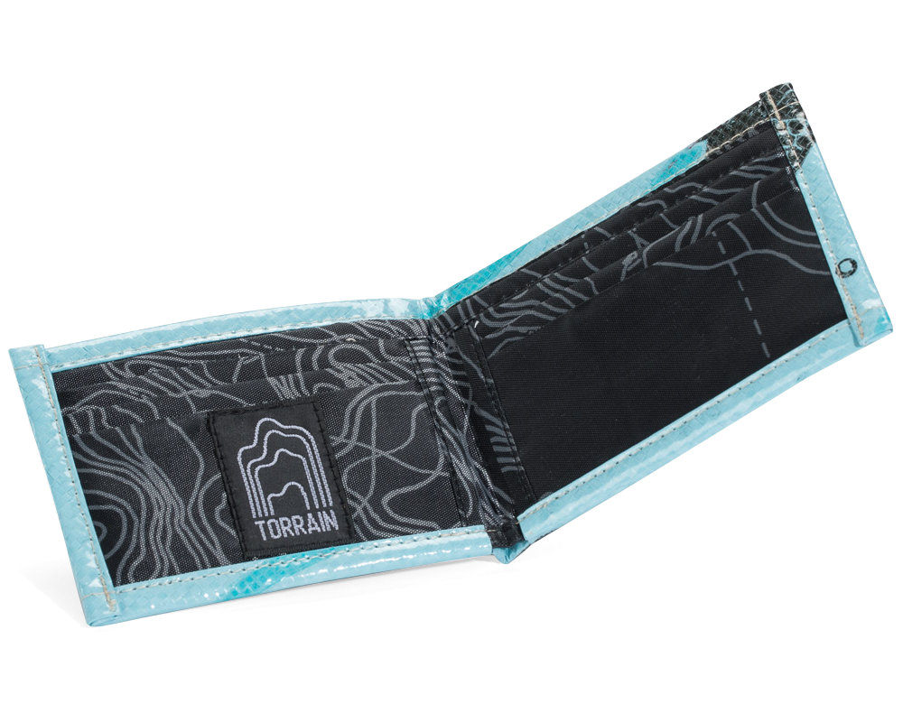 Open bi-fold wallet showing six interior slots (three on each side). Exterior material is upcycled from feed and cement bags, Interior material is recycled from plastic bottles. Each design is unique.