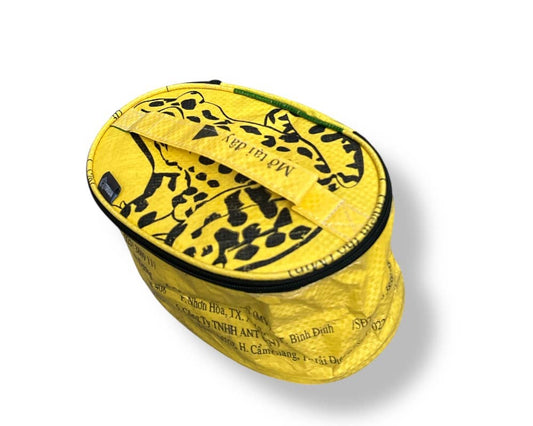 Oval travel pouch. Exterior material is upcycled from feed and cement bags, Interior material is recycled from plastic bottles. Each design is unique.
