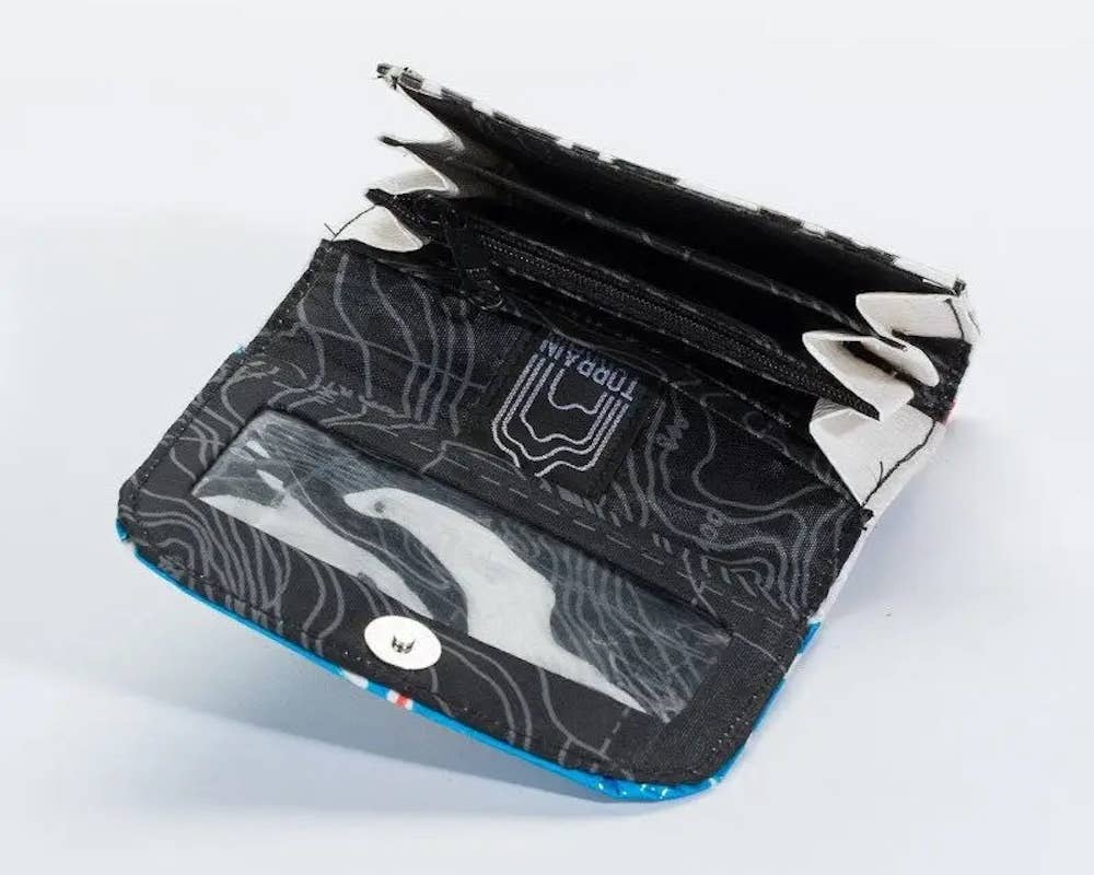 Folded wallet. Exterior material is upcycled from feed and cement bags, Interior material is recycled from plastic bottles. Each design is unique.