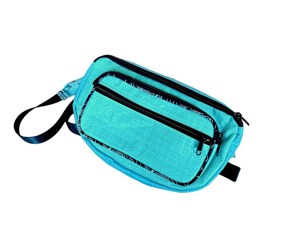 Small cross body pack. Exterior material is upcycled from feed and cement bags, Interior material is recycled from plastic bottles. Each design is unique.