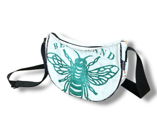 Cross body style bag. Exterior material is upcycled from feed and cement bags, Interior material is recycled from plastic bottles. Each design is unique.