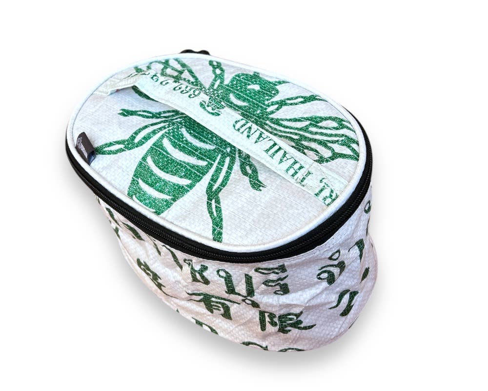 Oval travel pouch. Exterior material is upcycled from feed and cement bags, Interior material is recycled from plastic bottles. Each design is unique.