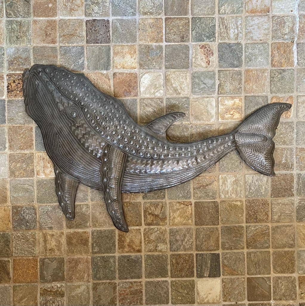 Handmade Haitian hammered metal wall art of a whale on tile