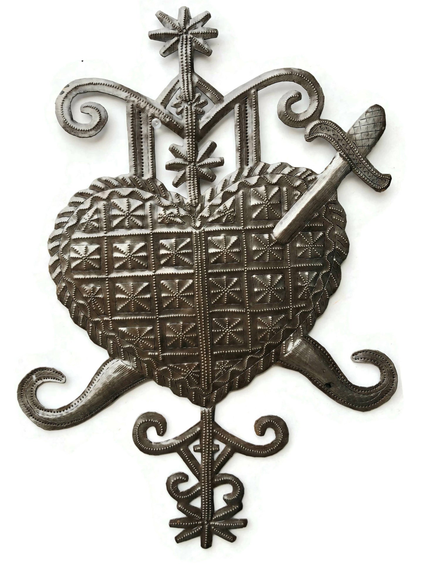 Handmade Haitian hammered metal wall art of a heart with a sword through it