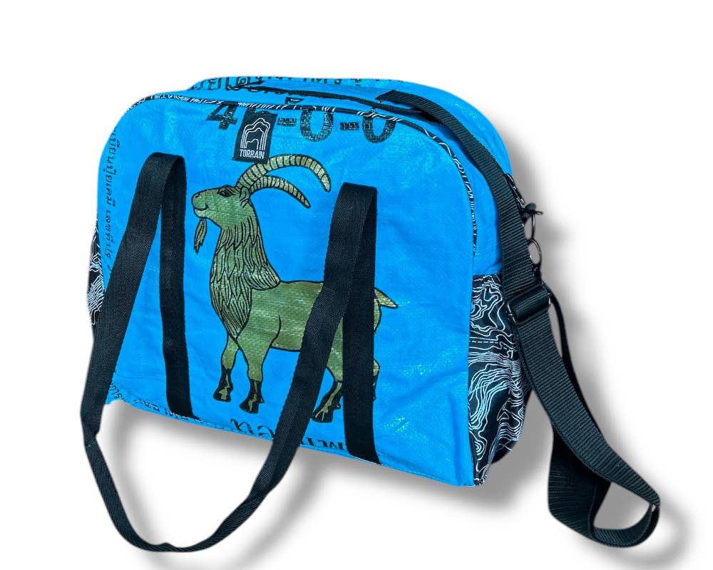 Bowler style duffle bag. Exterior material is upcycled from feed and cement bags, Interior material is recycled from plastic bottles. Each design is unique.