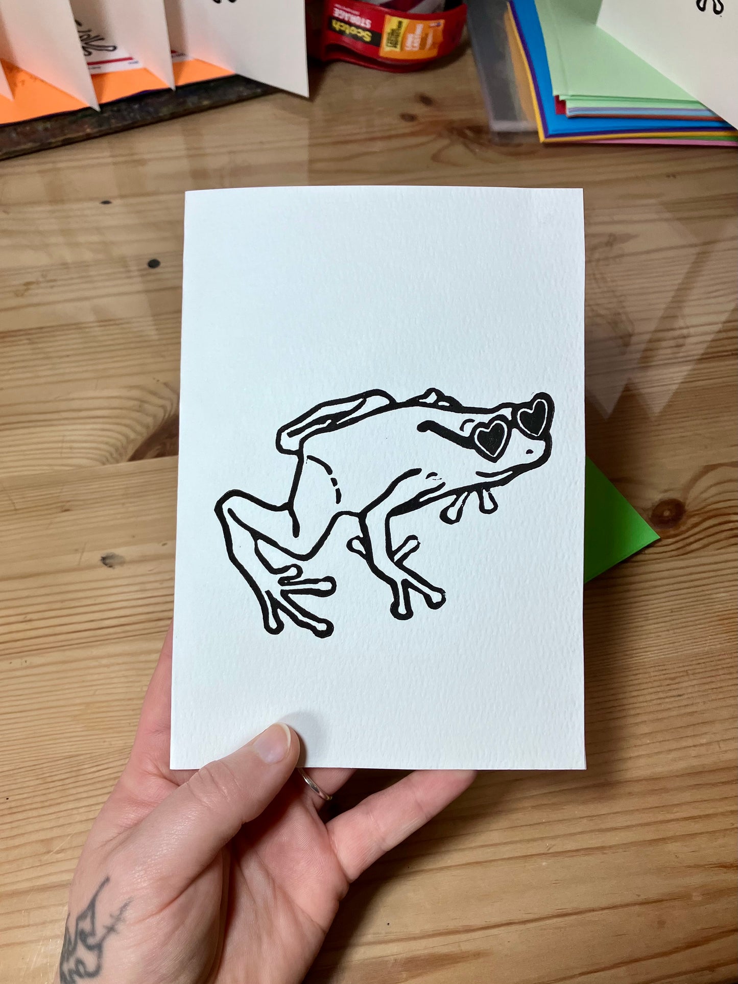 Greeting card designed with a frog wearing heart glasses