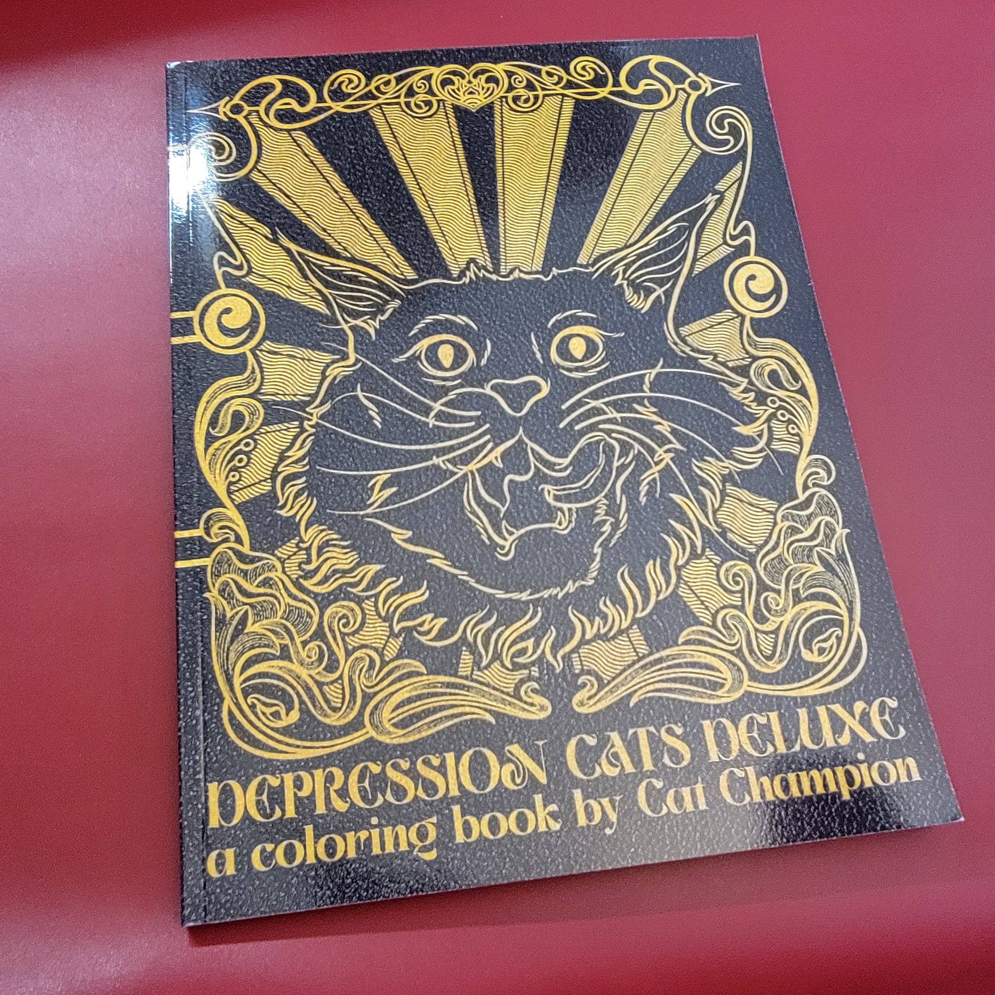 Coloring book cover with a cat illustration and text 'Depression Cats Deluxe a coloring book by Cat Champion'