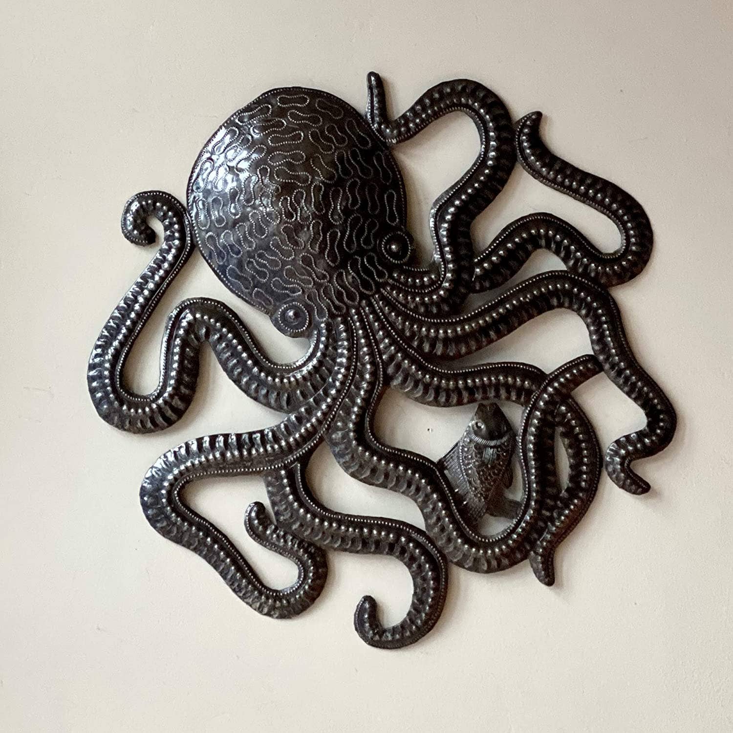 Handmade Haitian hammered metal wall art of an octopus and fish