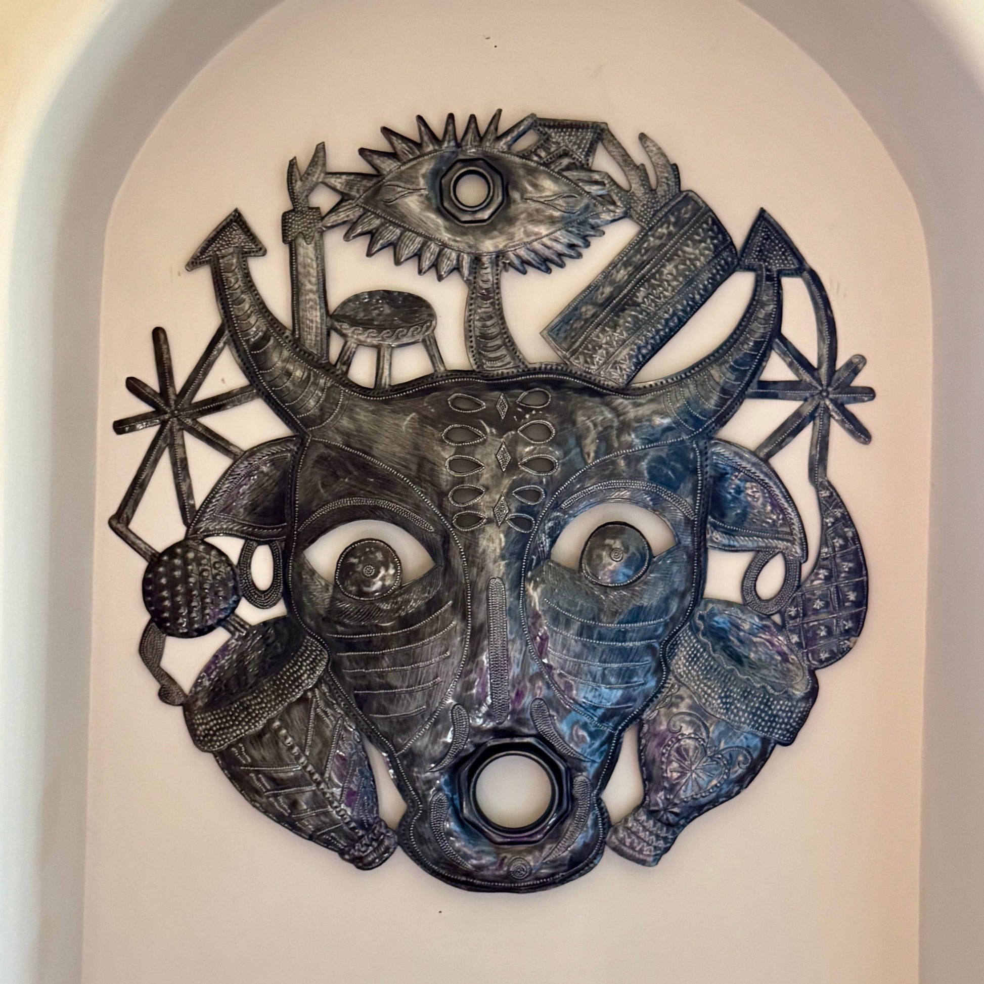Handmade Haitian hammered metal wall art of a bull spirit
