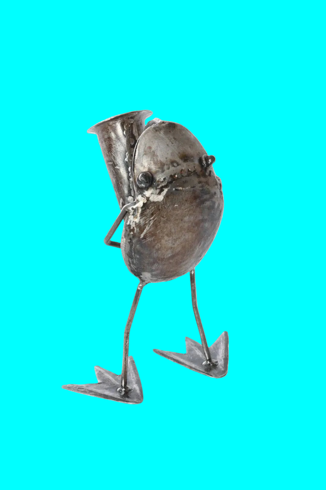Handcrafted metallic sculpture of a frog playing a horn - from the back.