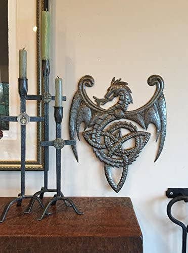Handmade Haitian hammered metal wall art of a dragon breathing fire hanging inside