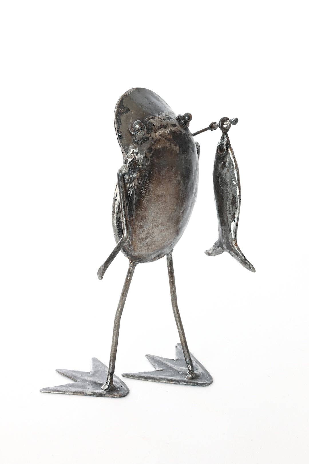 Metallic frog  holding a fishing pole with a fish on the end - from the back
