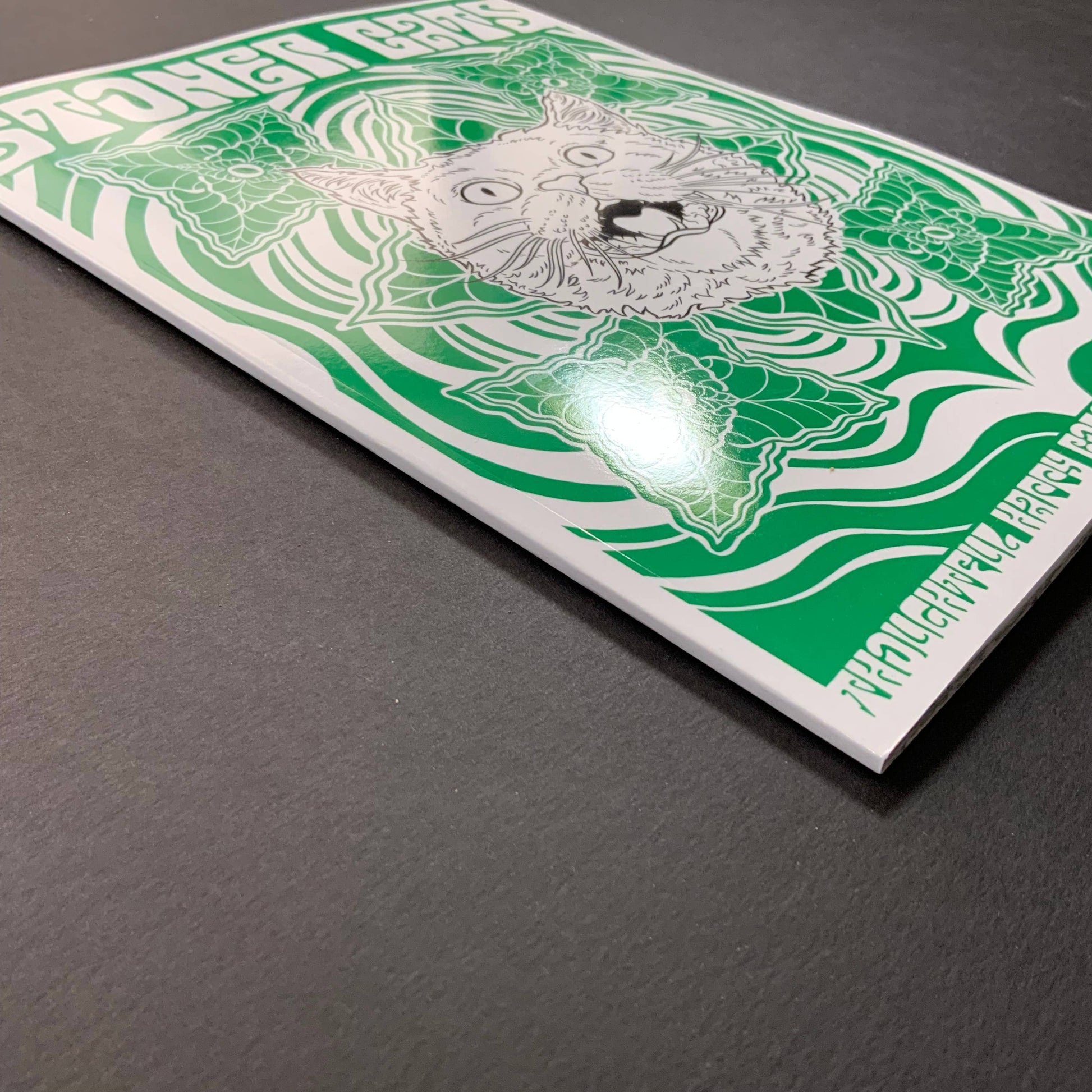 Stoner Cats coloring book with a cat illustration and green patterns
