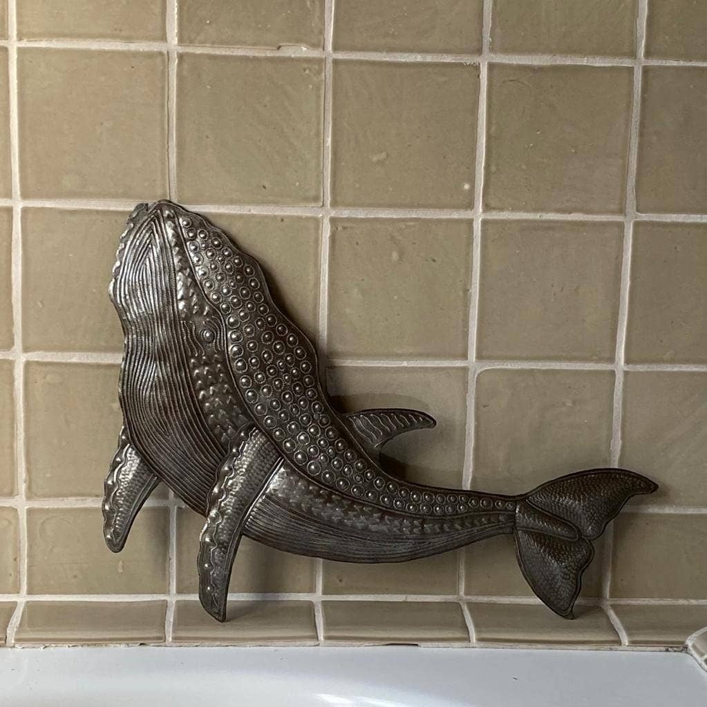 Handmade Haitian hammered metal wall art of a whale insdie