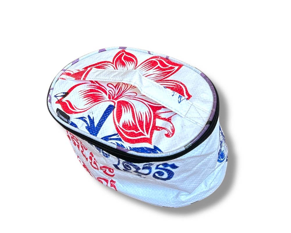 Oval travel pouch. Exterior material is upcycled from feed and cement bags, Interior material is recycled from plastic bottles. Each design is unique.