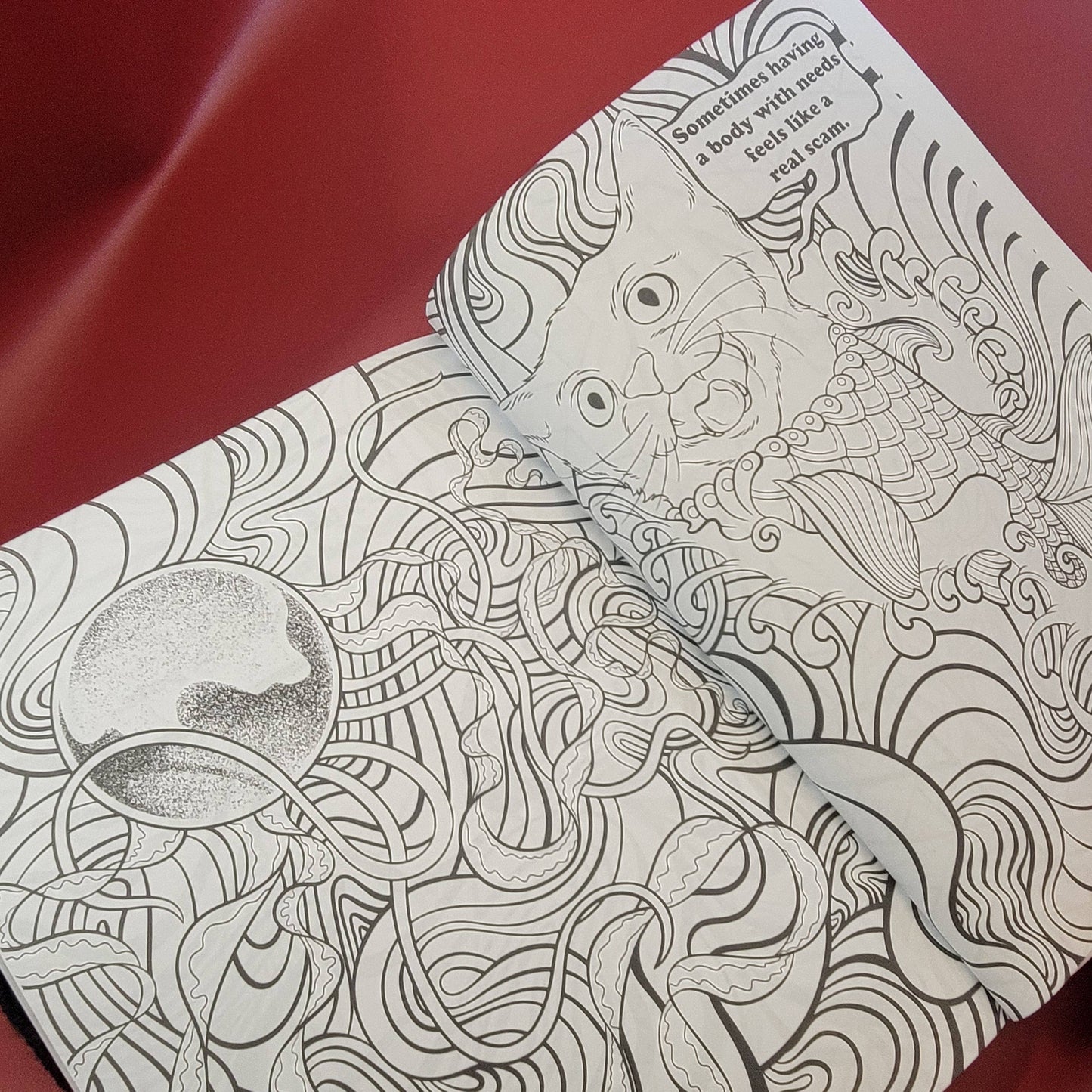 Open coloring book with intricate black line art