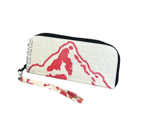 Zip wallet with tassel. Exterior material is upcycled from feed and cement bags, Interior material is recycled from plastic bottles. Each design is unique.