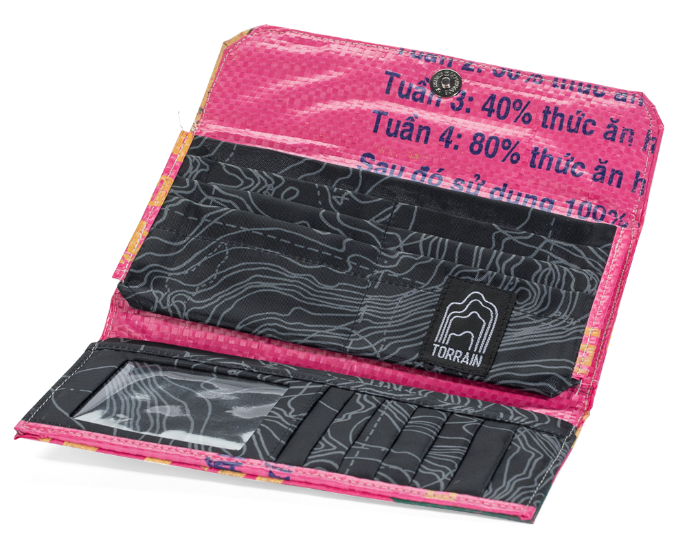 Open Tri-fold wallet. showing the interior pockets. Exterior material is upcycled from feed and cement bags, Interior material is recycled from plastic bottles. Each design is unique.
