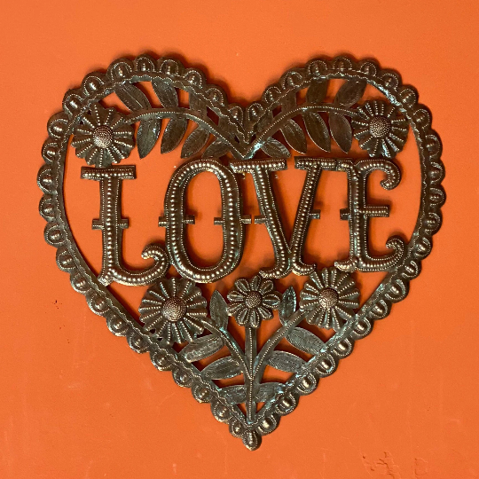 Handmade Haitian hammered metal wall art of a heart with the word Love surrounded by flowers