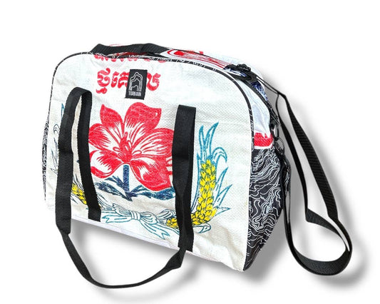 Bowler style duffle bag. Exterior material is upcycled from feed and cement bags, Interior material is recycled from plastic bottles. Each design is unique.