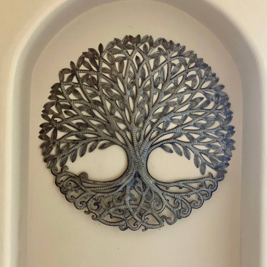 Handmade hammered metal wall art of a tree with intricate designs