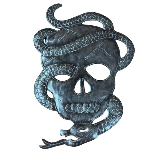 Handmade Haitian hammered metal wall art of a skull with a snake entwined
