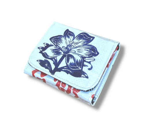 Folded wallet. Exterior material is upcycled from feed and cement bags, Interior material is recycled from plastic bottles. Each design is unique.