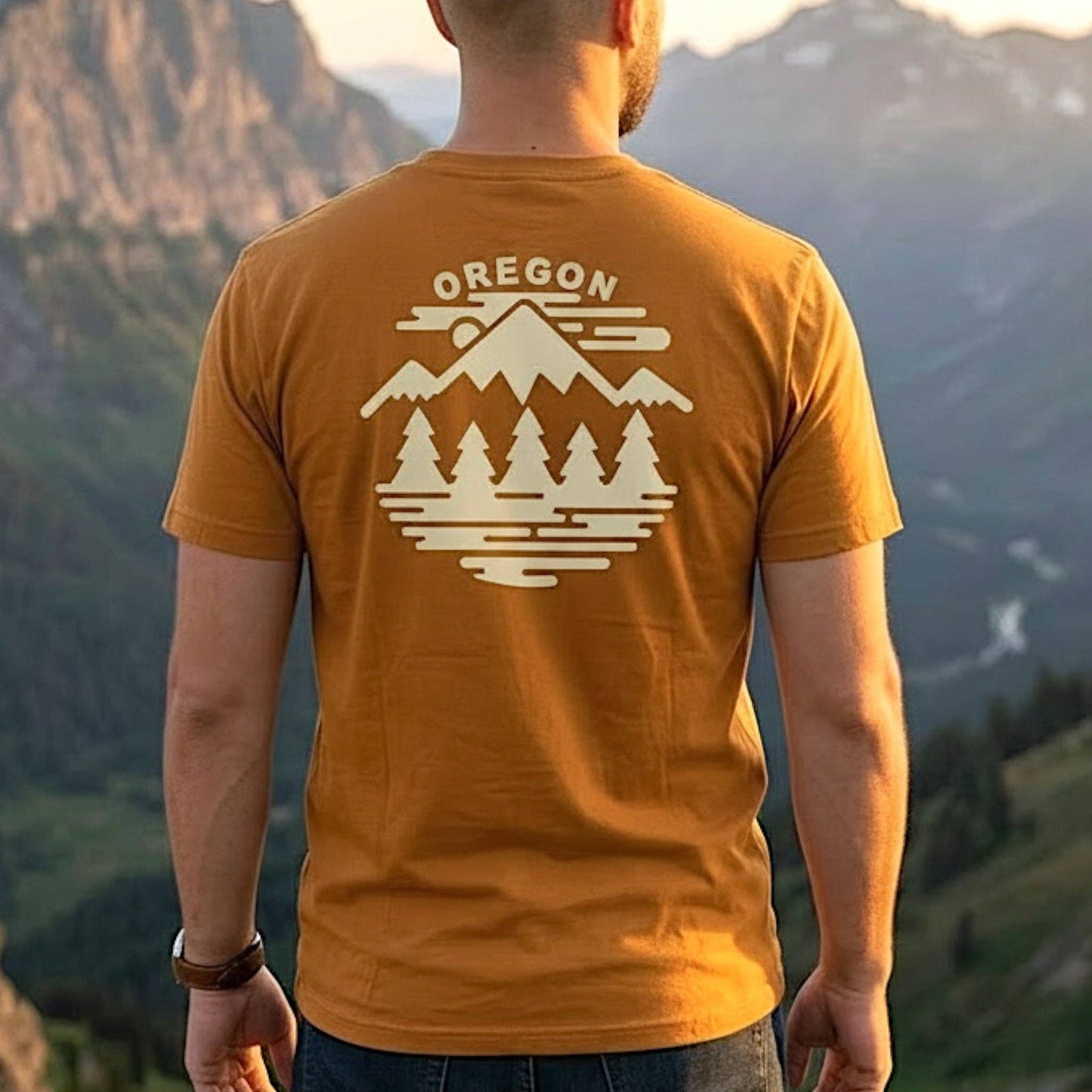 Person wearing a mustard yellow t-shirt  showing the back with 'Oregon' and mountain design