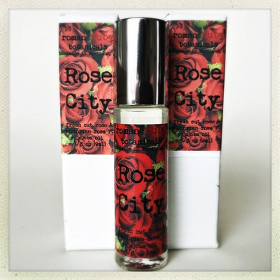Roman Ruby Rose City perfume bottle with red and black packaging on a white background